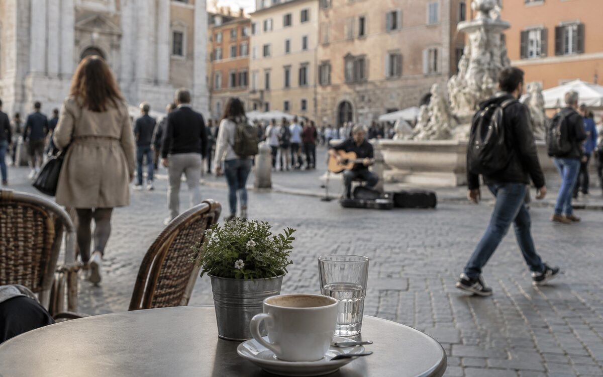 A busy public square photographed from a cafe table — ordinary crowd movement, nothing dramatic happening